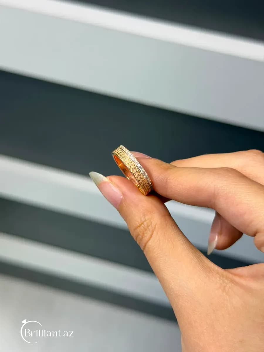 Women's ring — gold-colored, band design with a metallic pattern
