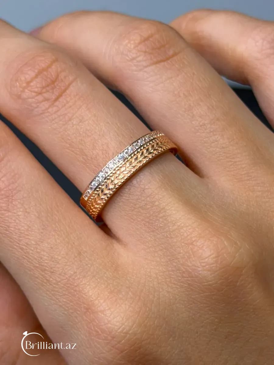 Women's ring — gold-colored, band design with a metallic pattern