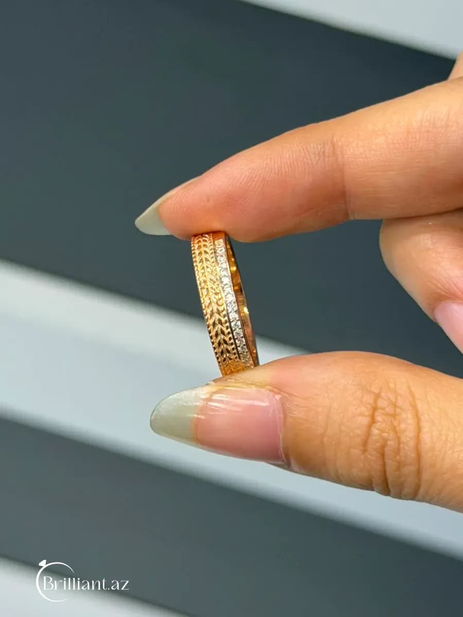 Women's ring — gold-colored, band design with a metallic pattern